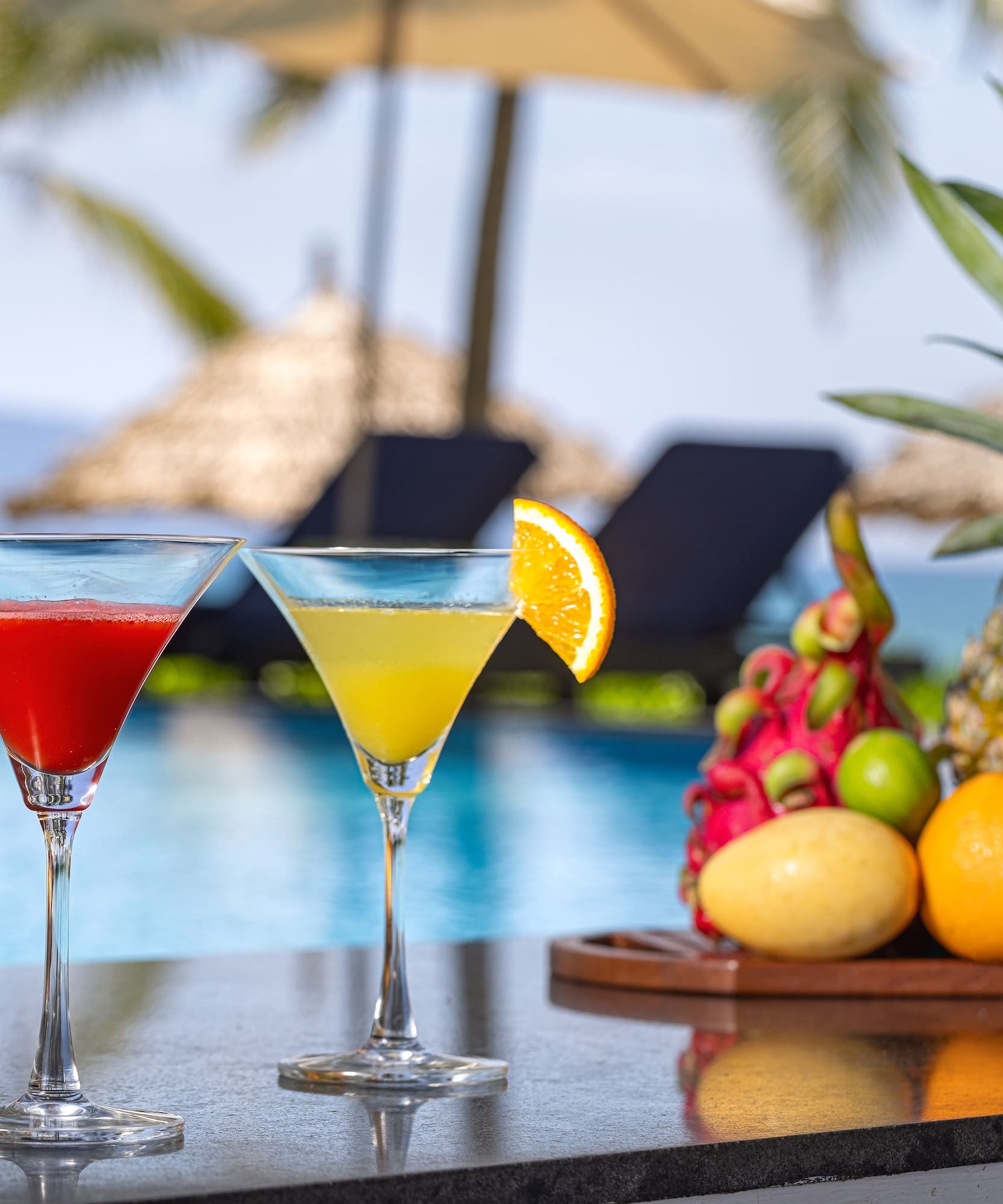 two glasses of drinks on a bar