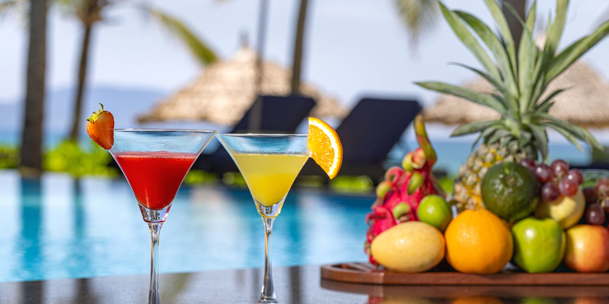 two glasses of drinks on a bar