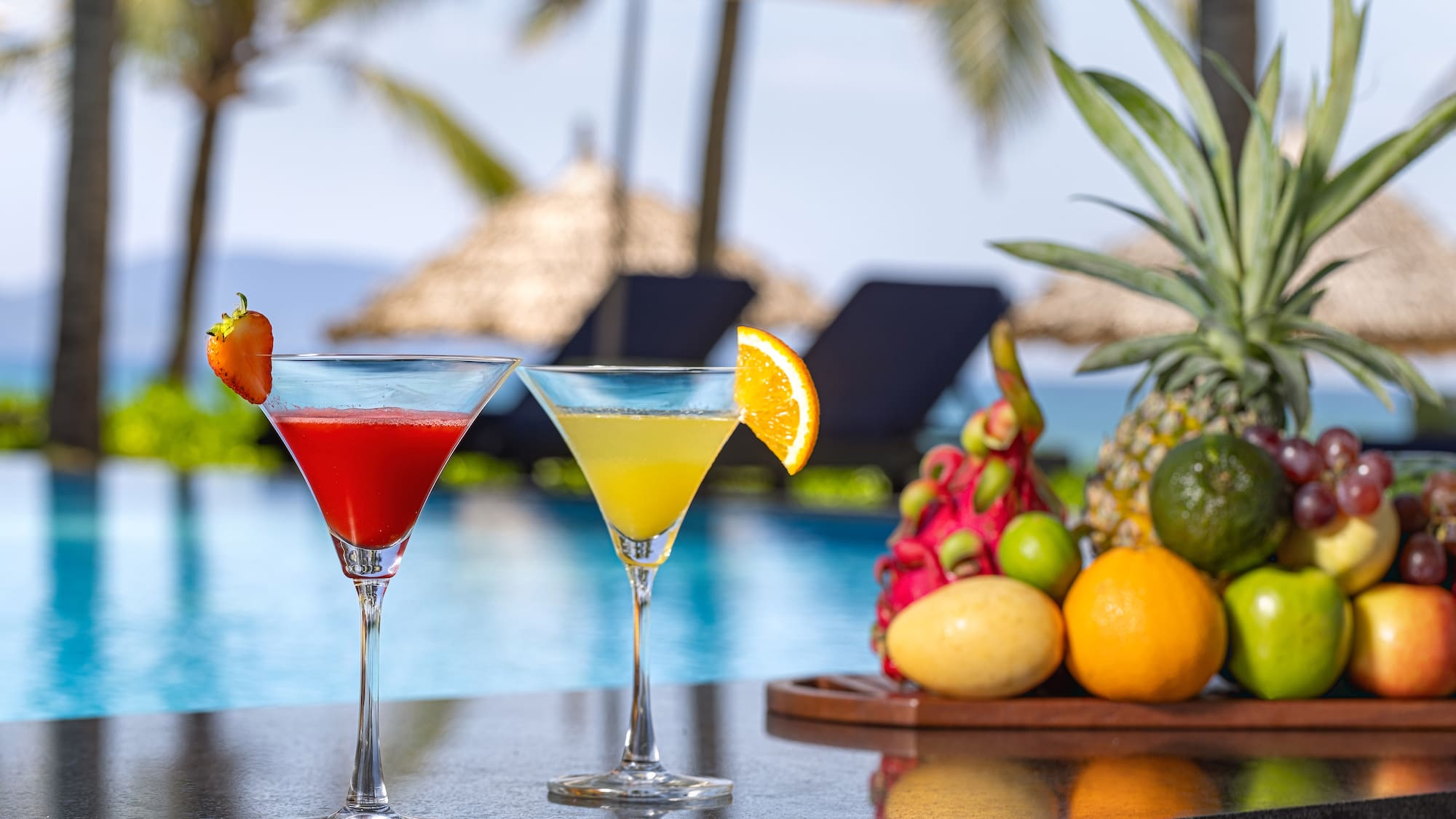 two glasses of drinks on a bar