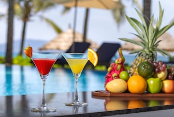 two glasses of drinks on a bar