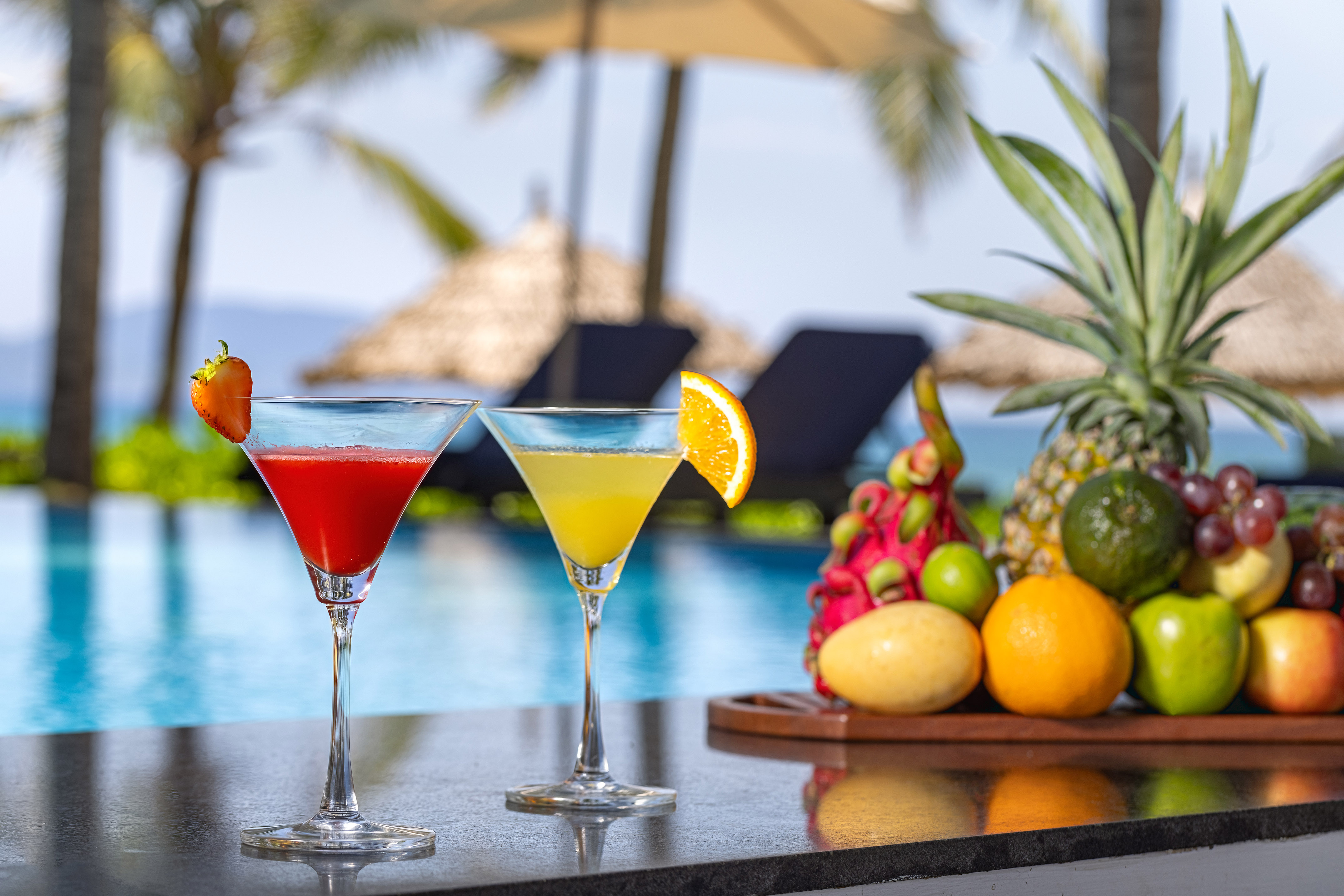 two glasses of drinks on a bar