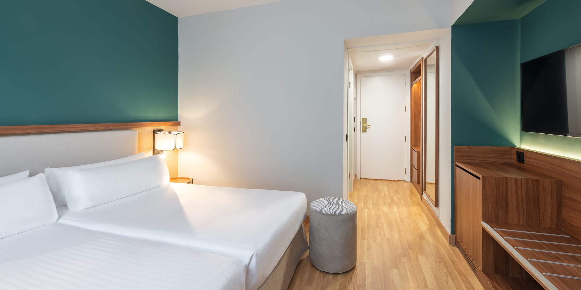 a room with two beds and a wood floor