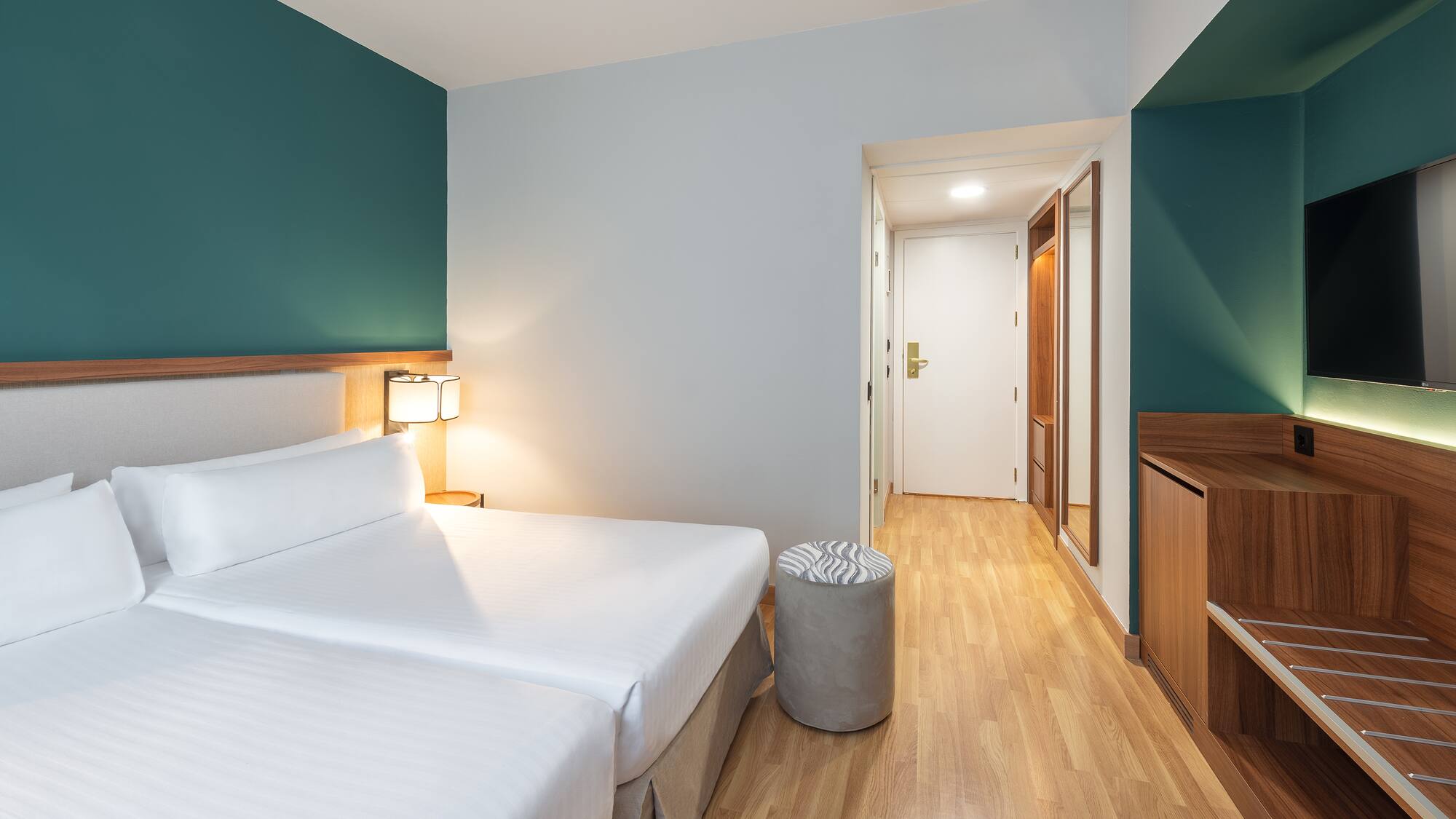 a room with two beds and a wood floor