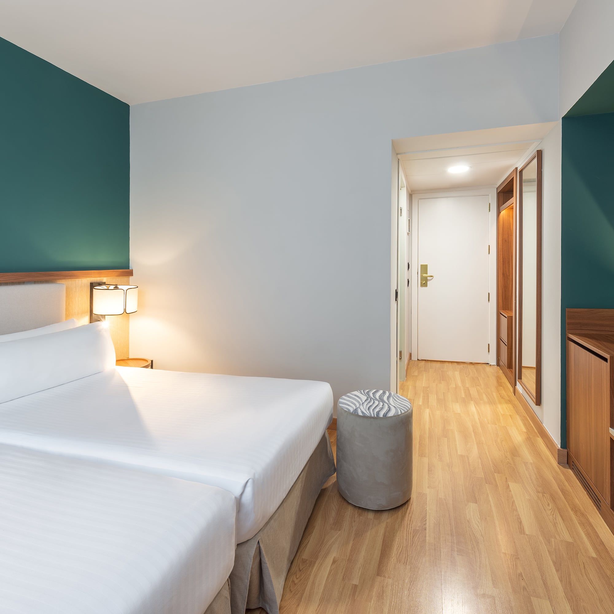 a room with two beds and a wood floor