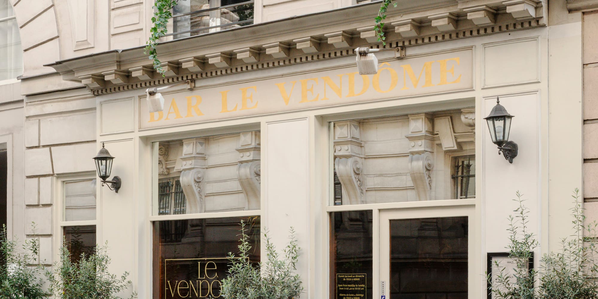 a building with windows and plants