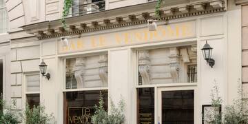 a building with windows and plants