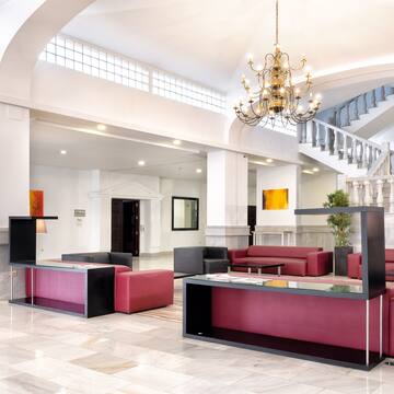 a lobby with a chandelier and couches