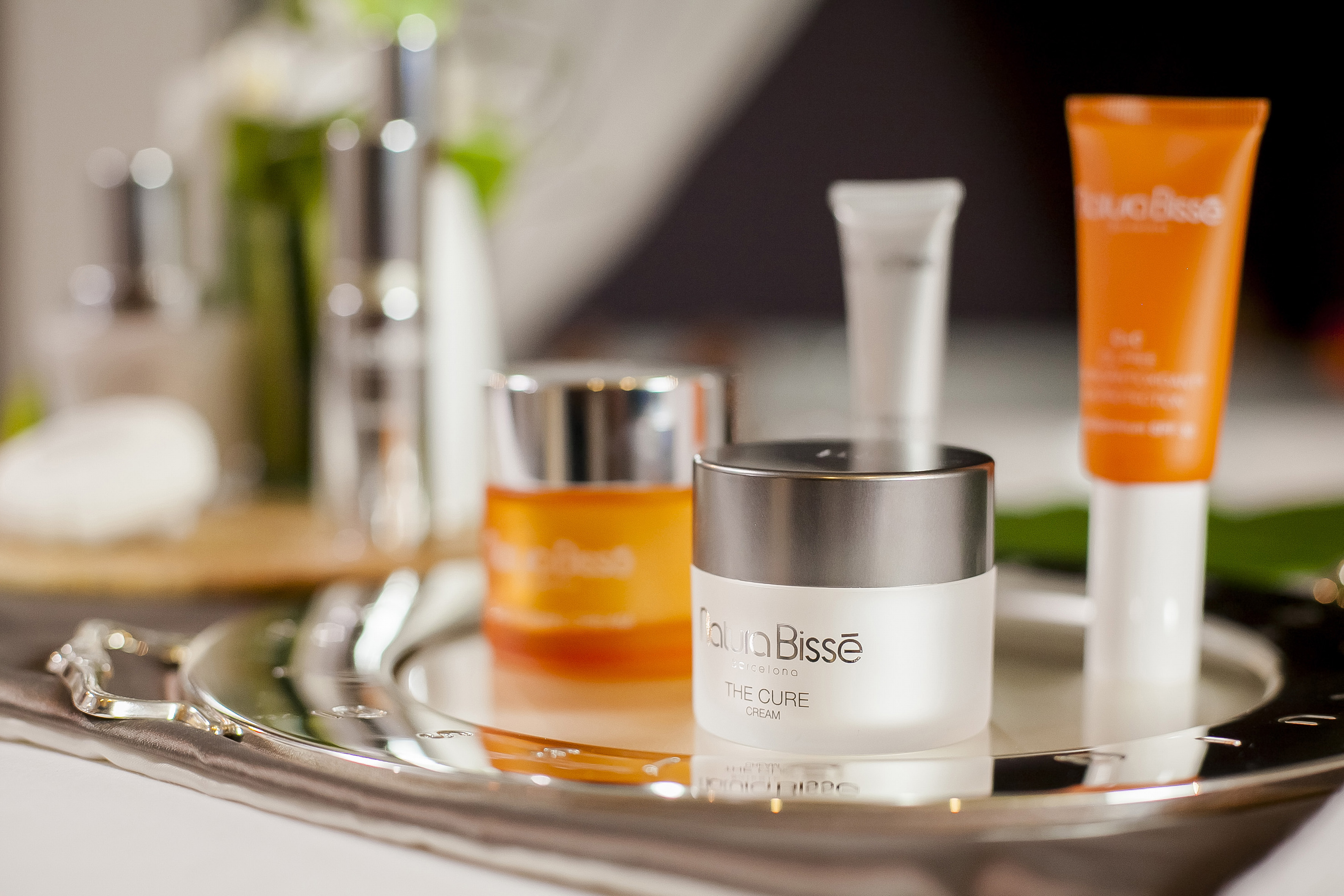 a group of cosmetic containers on a tray