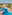 Resort hotel with winding blue pool, palm trees, sun loungers, ocean view.