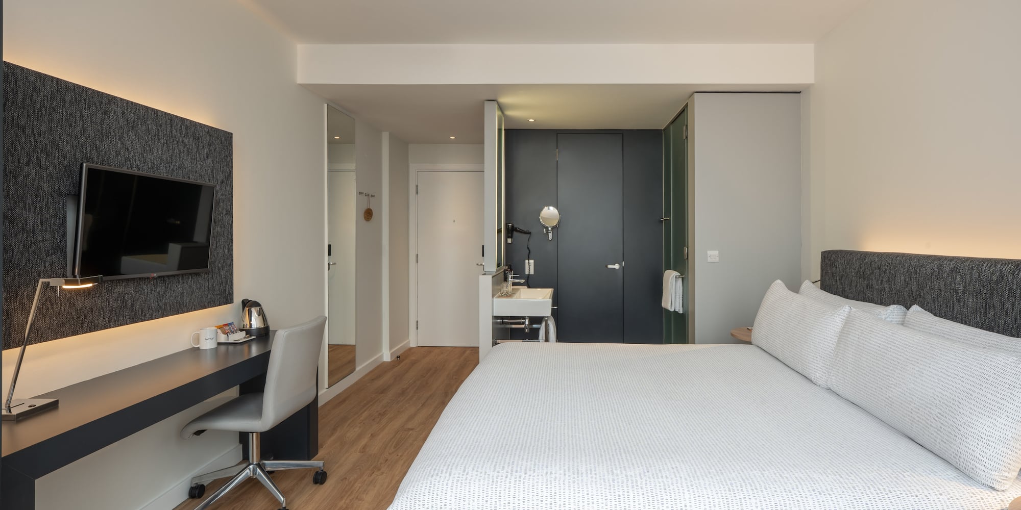 a bedroom with a bed and a desk