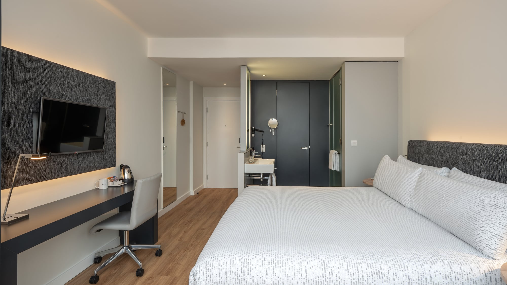 a bedroom with a bed and a desk