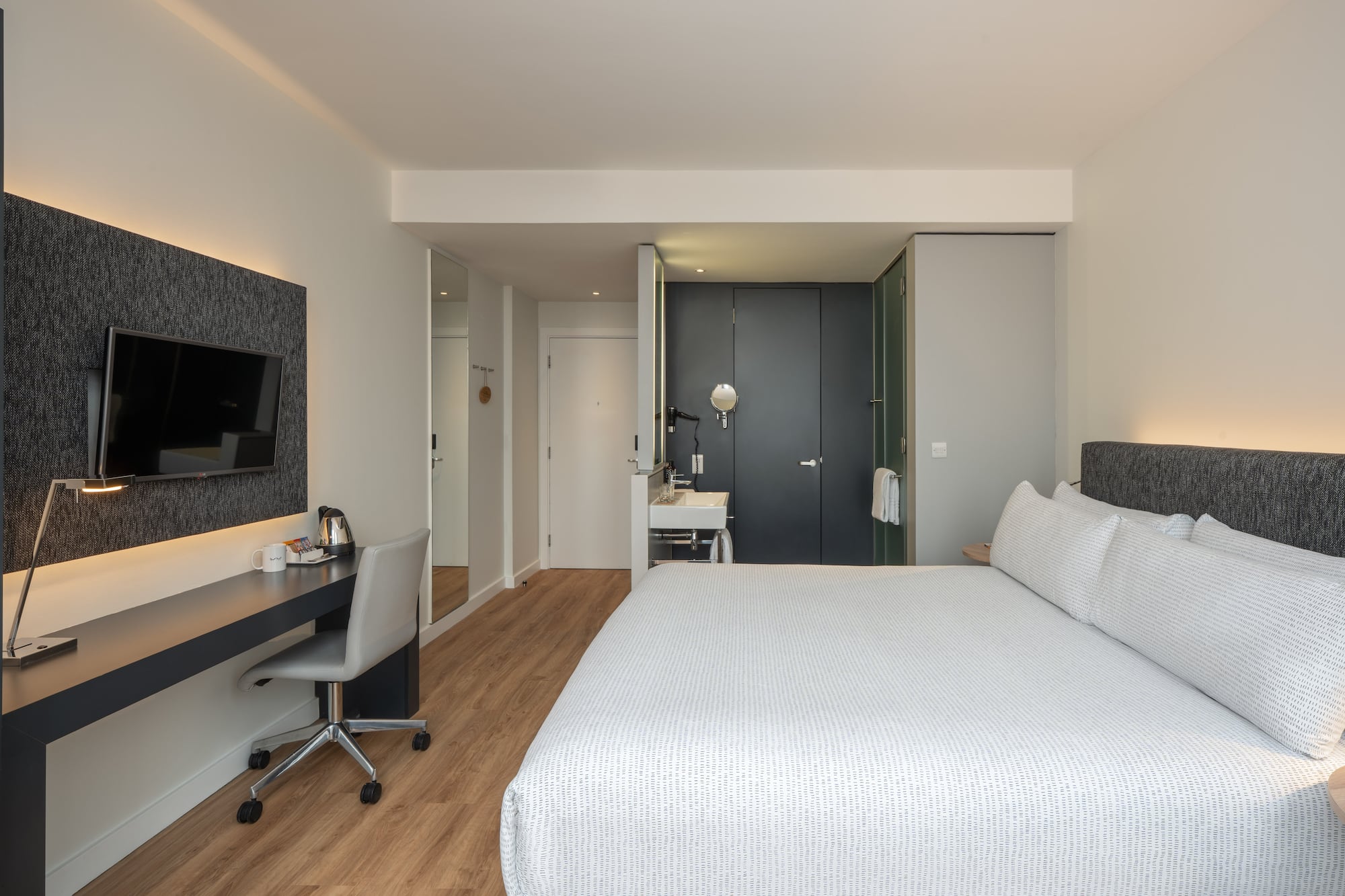 a bedroom with a bed and a desk