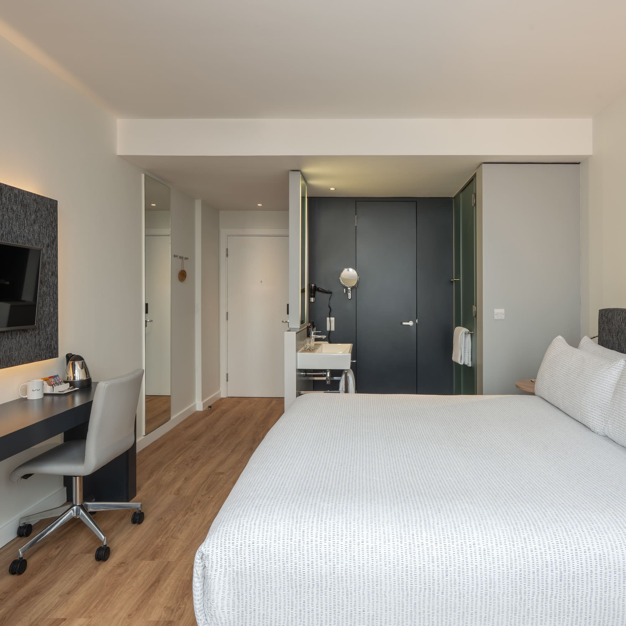 a bedroom with a bed and a desk