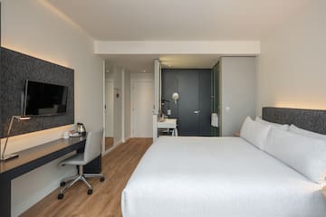 a bedroom with a bed and a desk