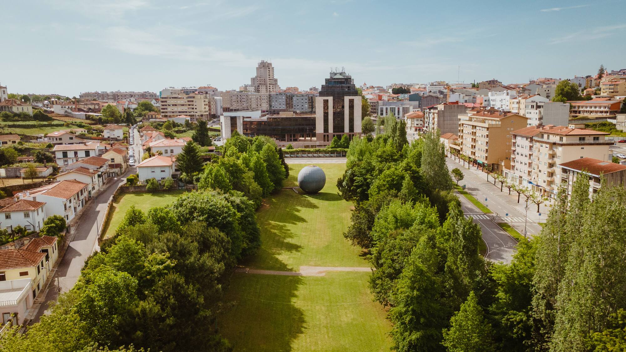 a large ball in a park surrounded by trees