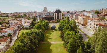 a large ball in a park surrounded by trees