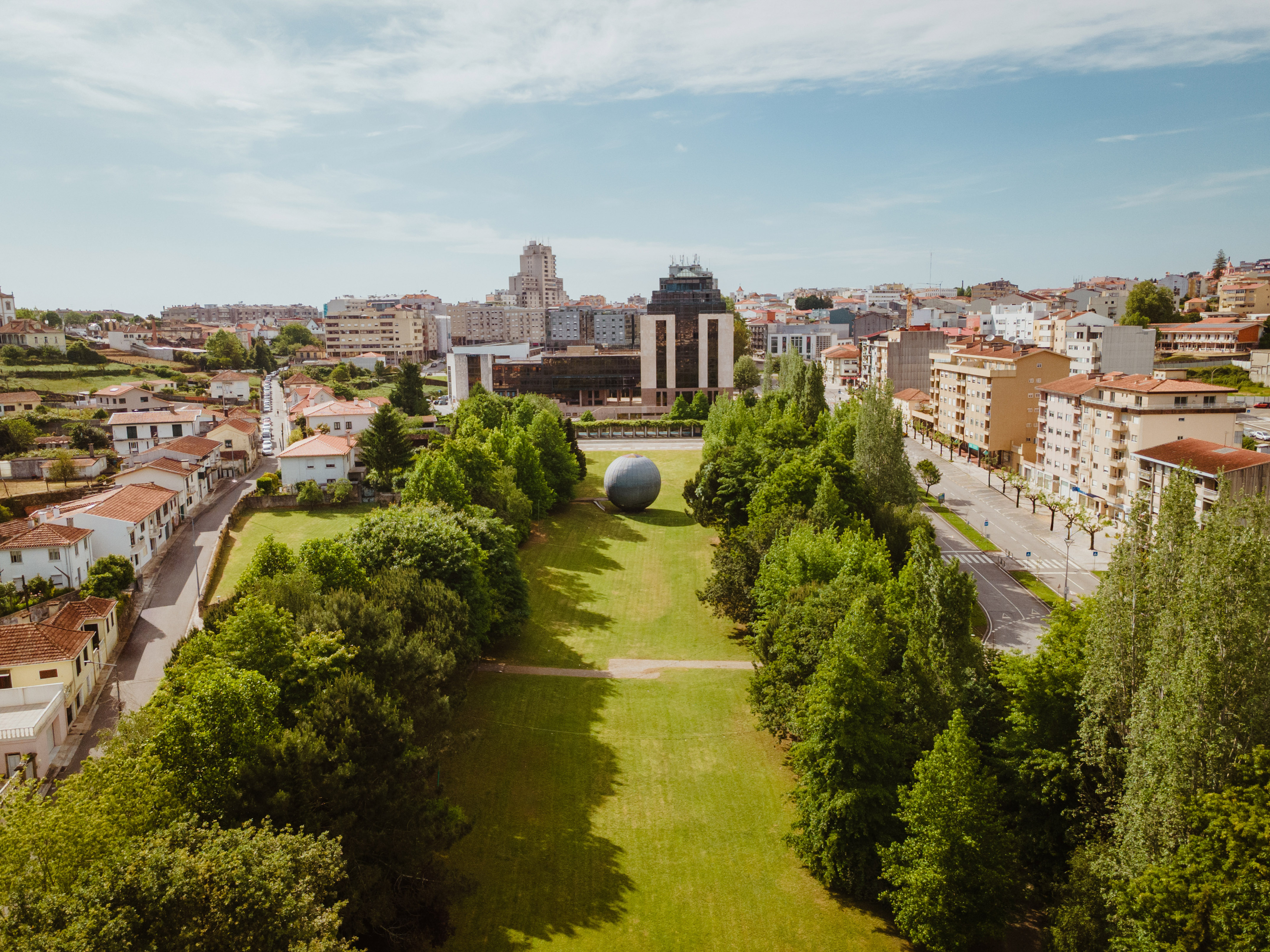 a large ball in a park surrounded by trees