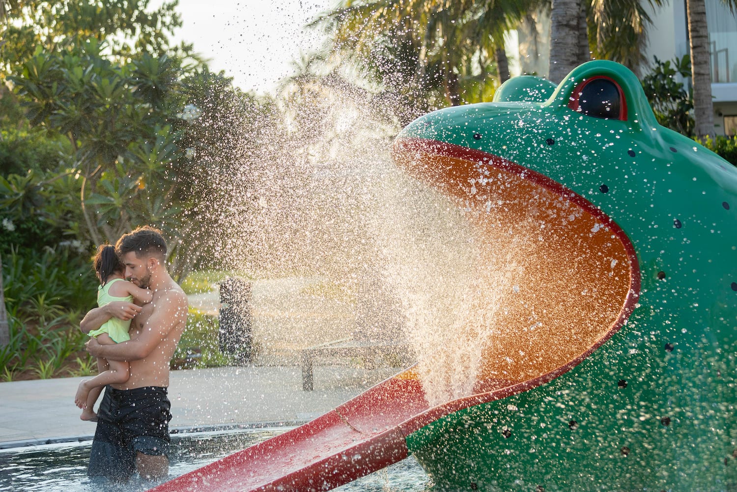 a man and child playing in a water park
