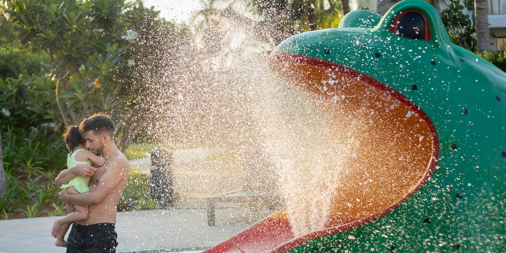 a man and child playing in a water park