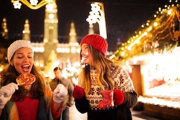 two women holding sparklers and smiling