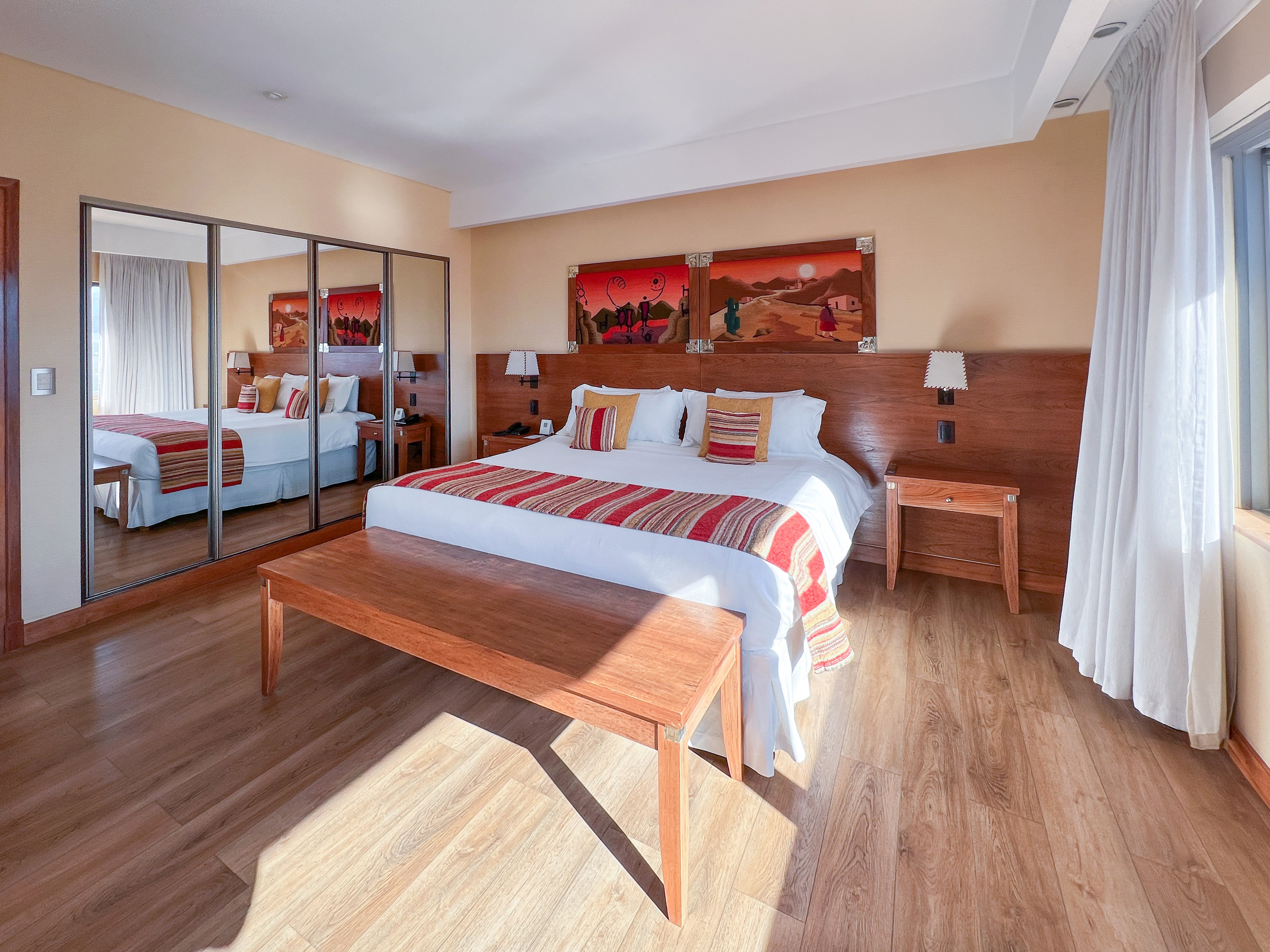 a room with a bed and mirror