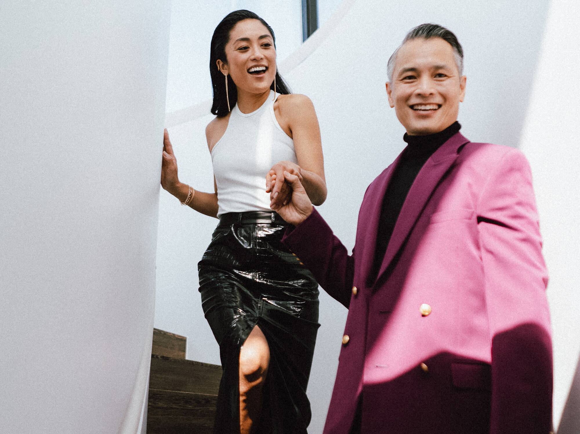 a man and woman walking down stairs