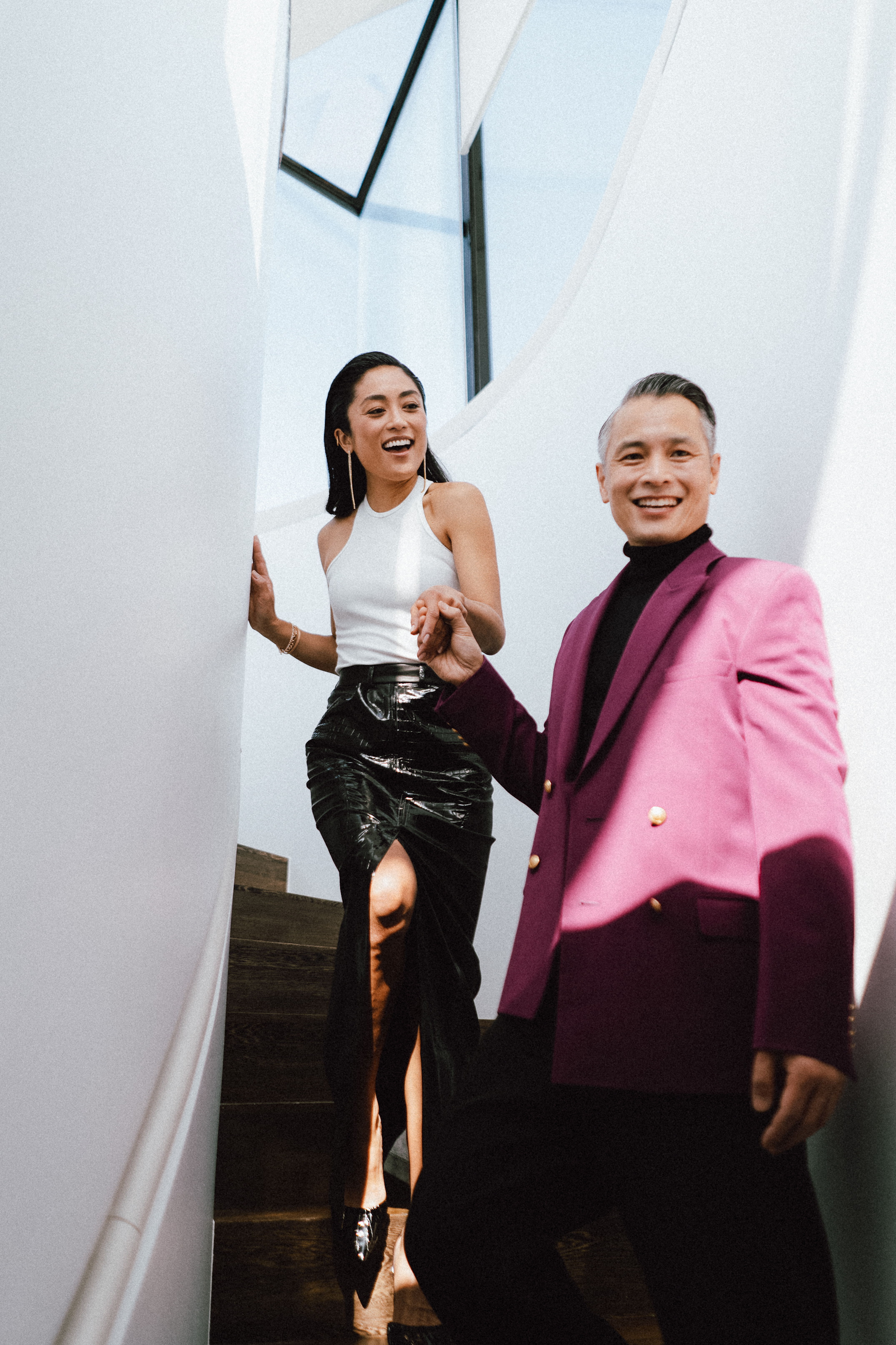 a man and woman walking down stairs
