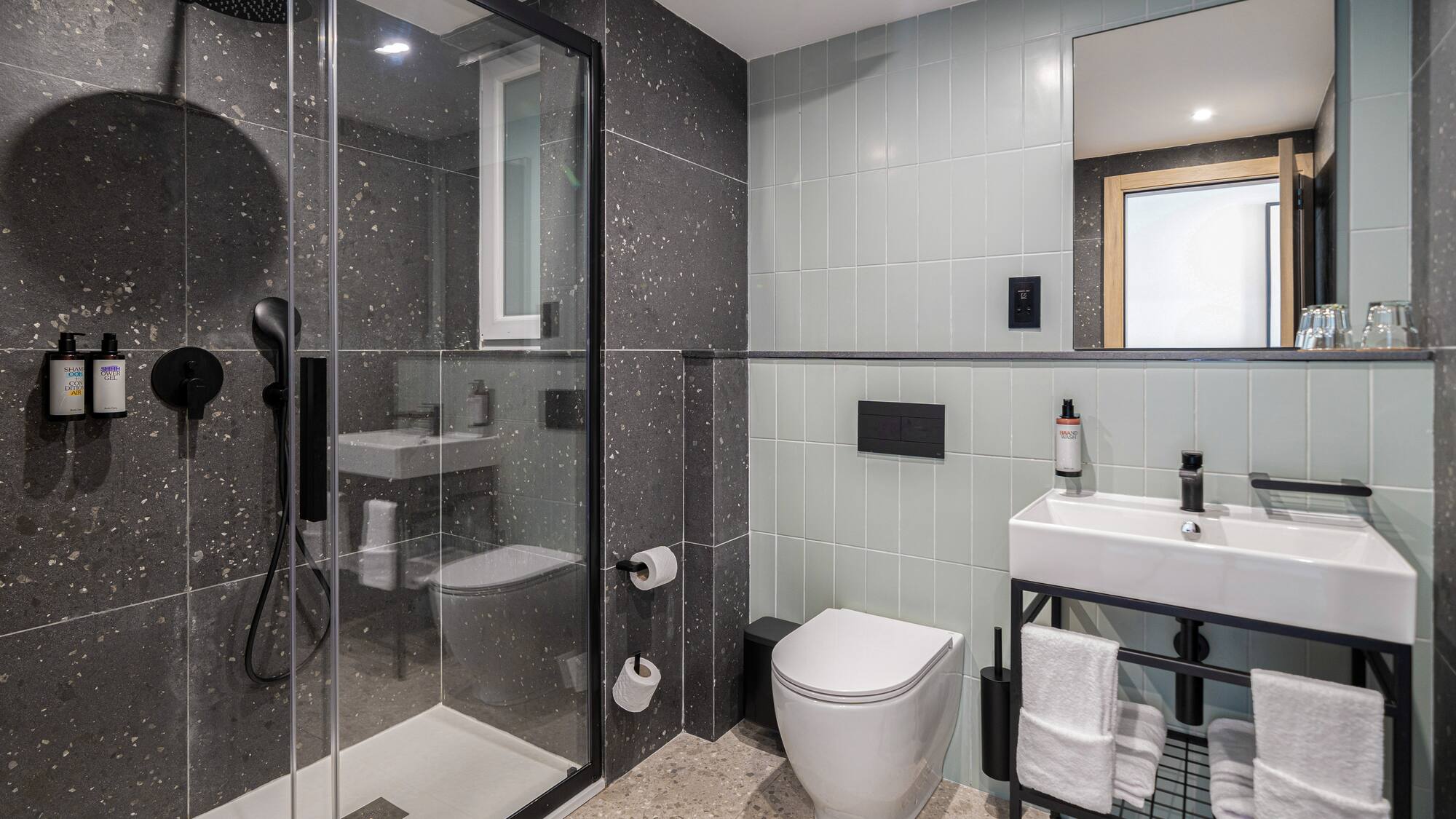 a bathroom with a glass shower and sink