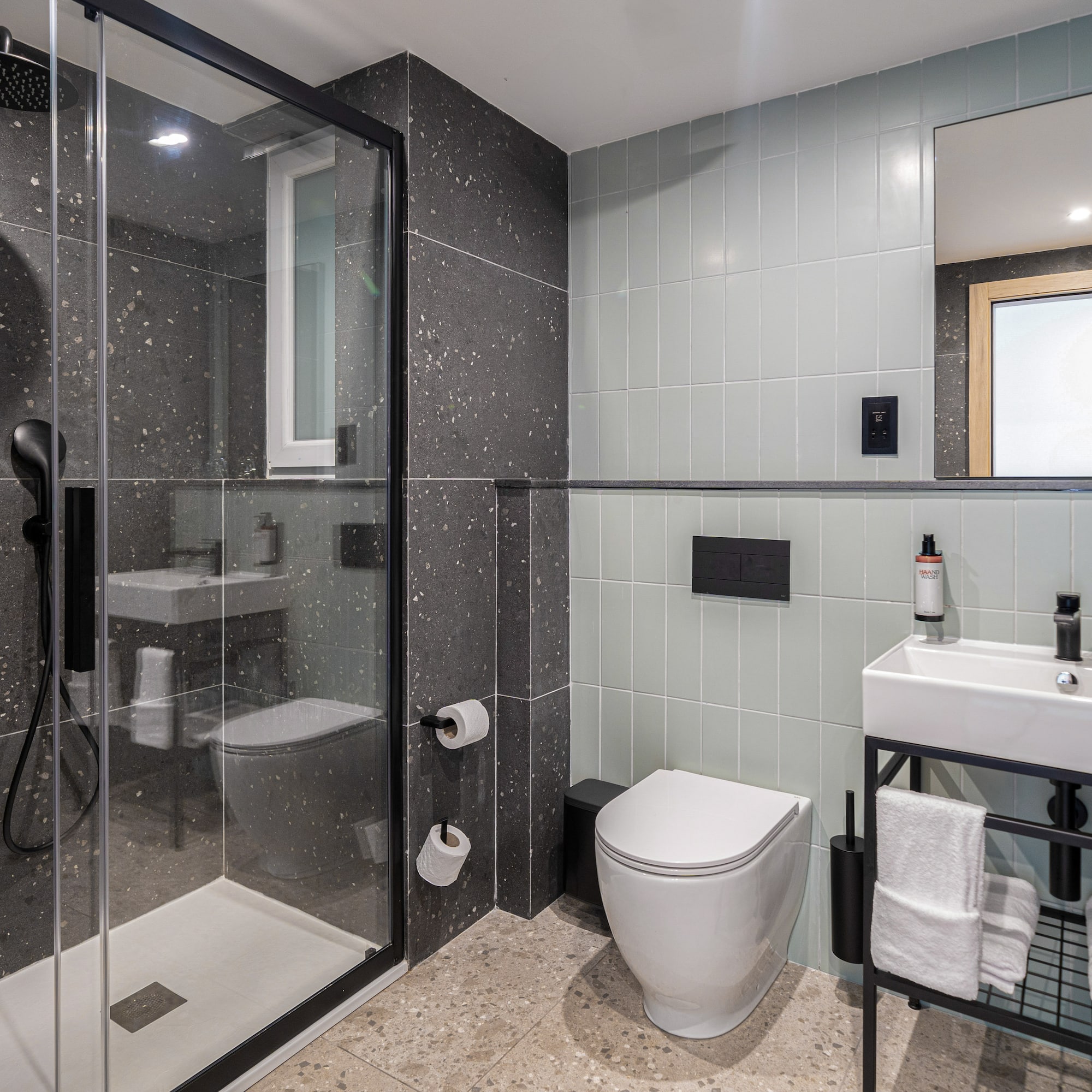 a bathroom with a glass shower and sink