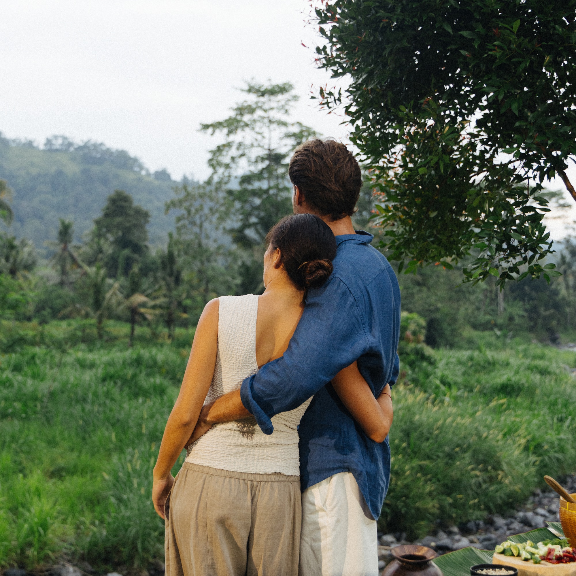 a man and woman hugging outside