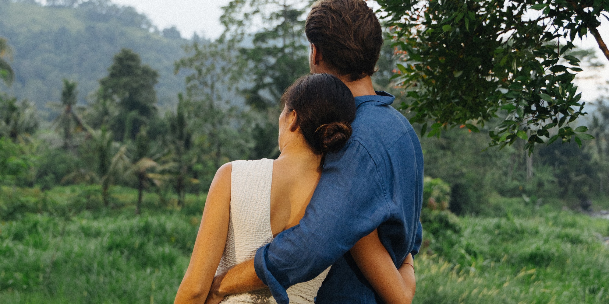 a man and woman hugging outside
