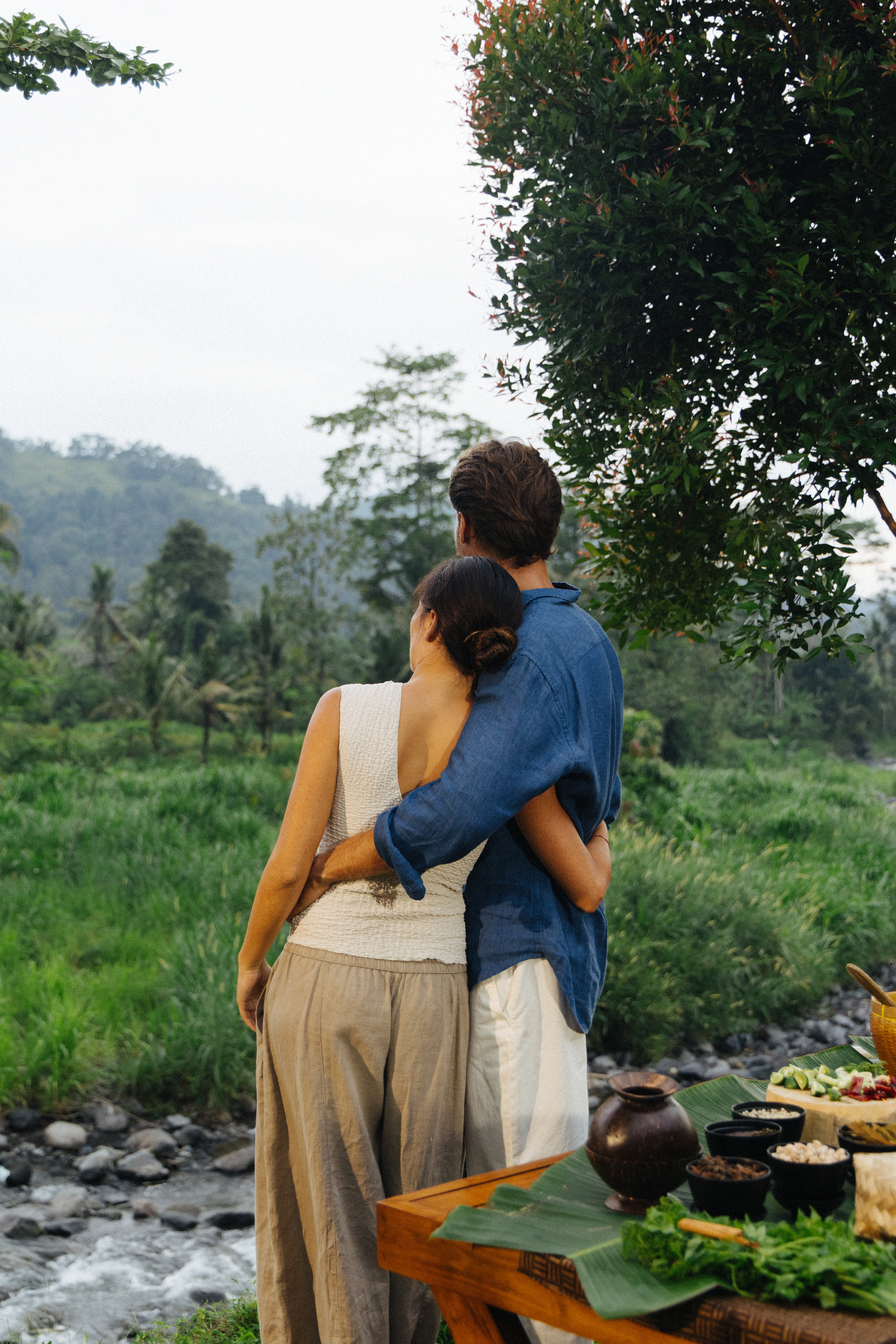 a man and woman hugging outside