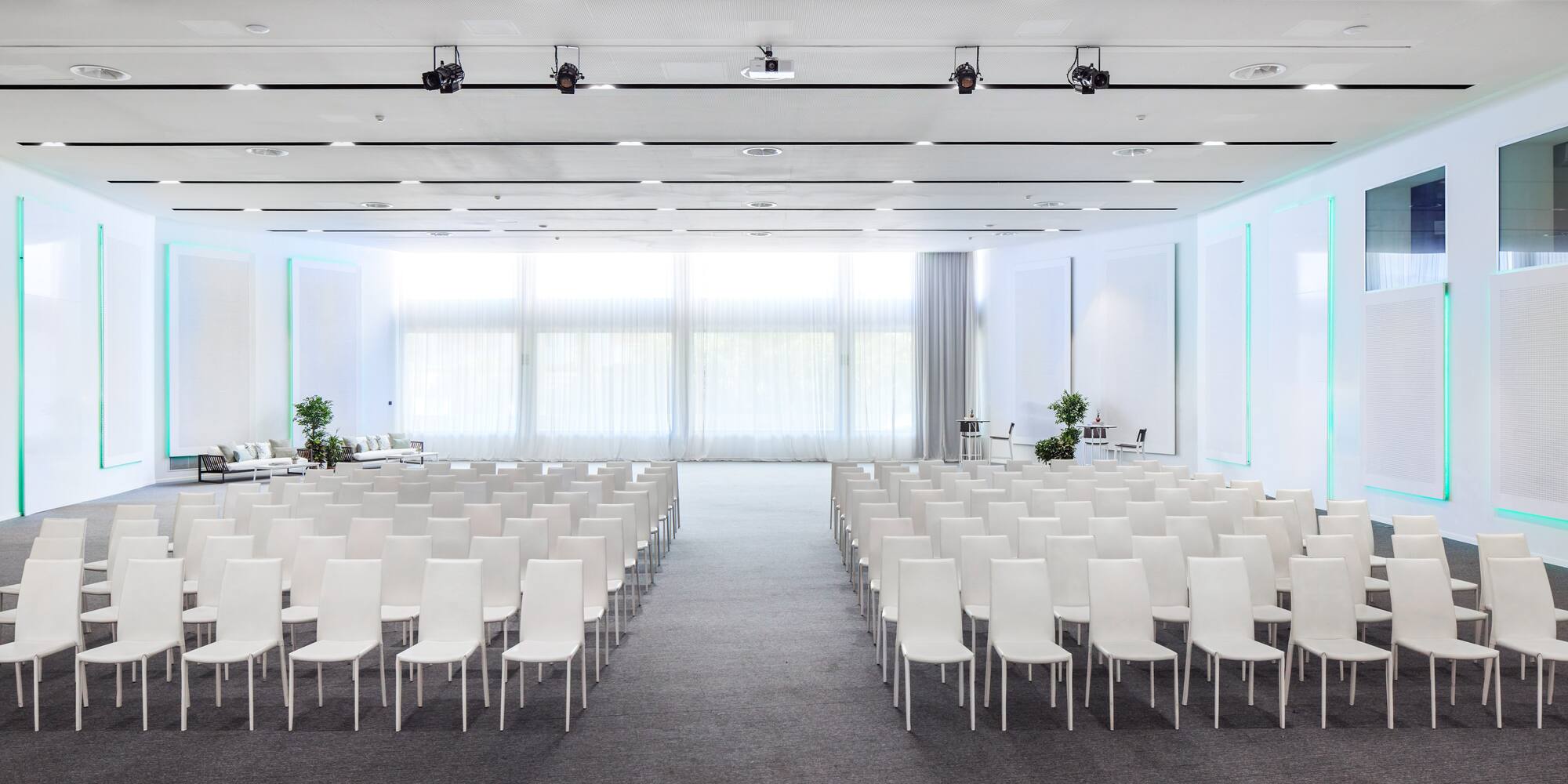 a room with white chairs and tables