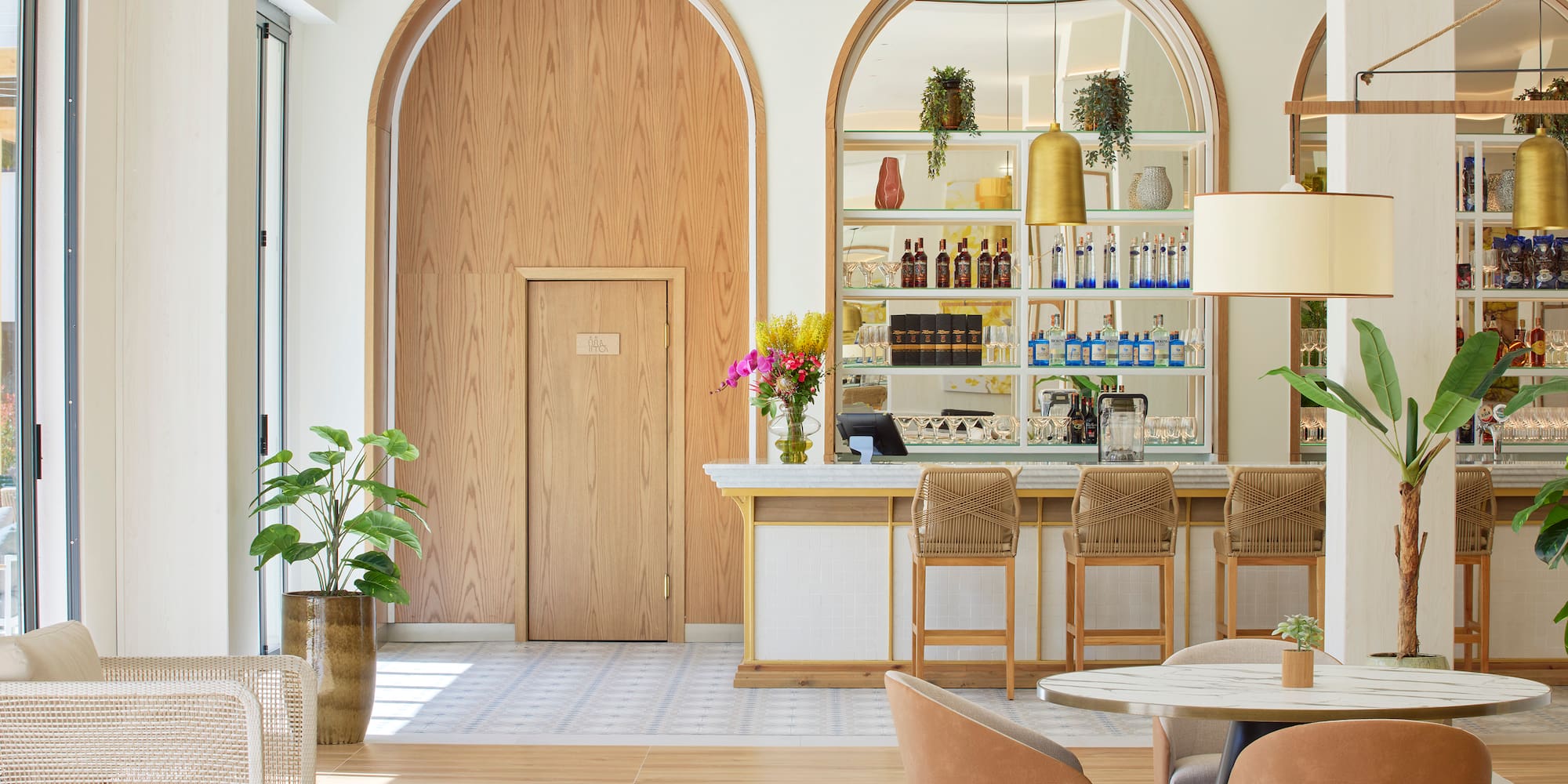 a room with a bar and chairs