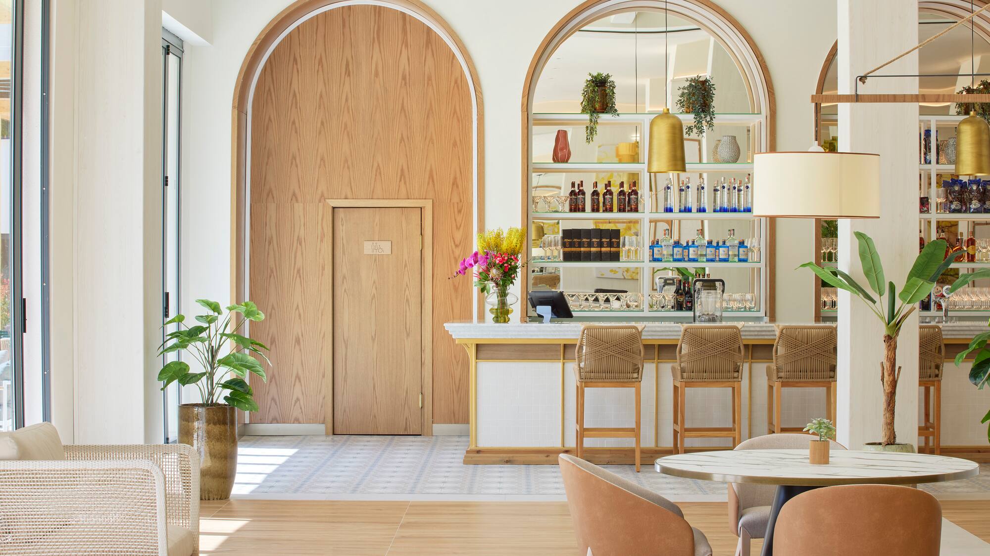 a room with a bar and chairs