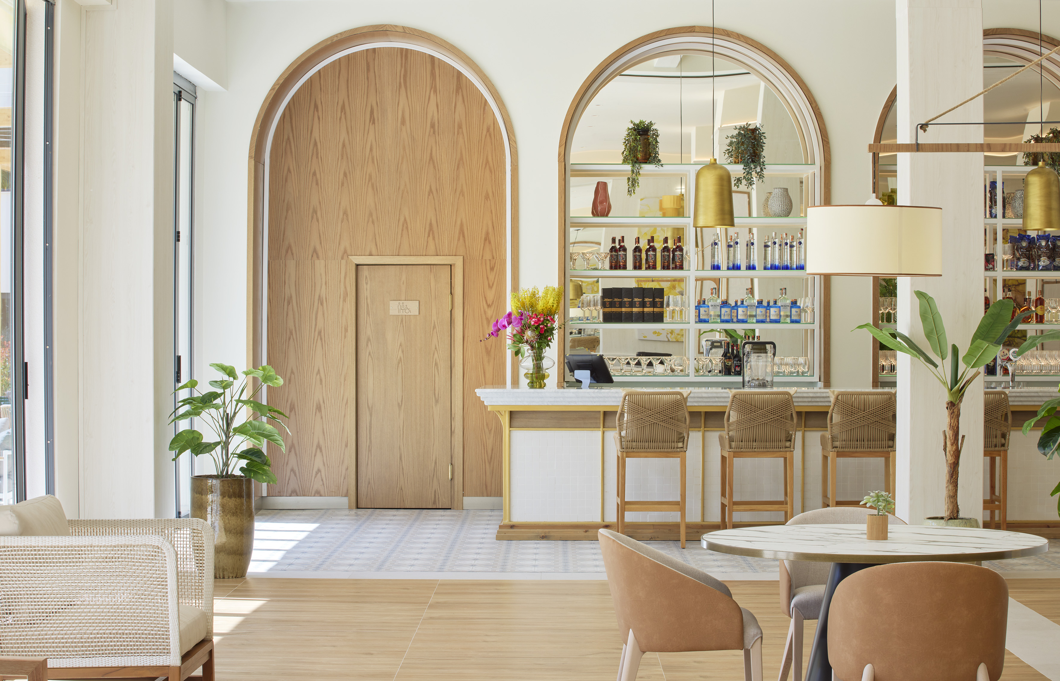 Modern bar lounge with arched wood paneling, full bar, and stylish seating.