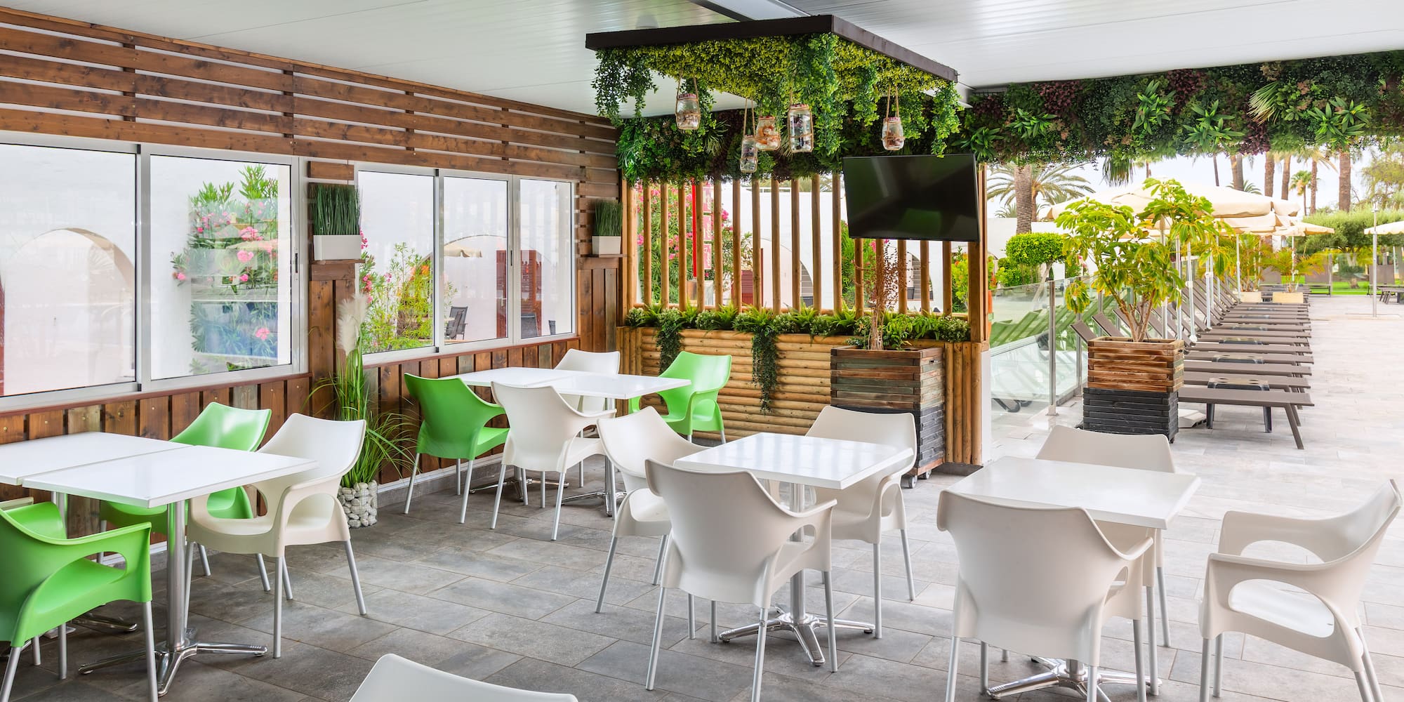 a patio with white tables and chairs