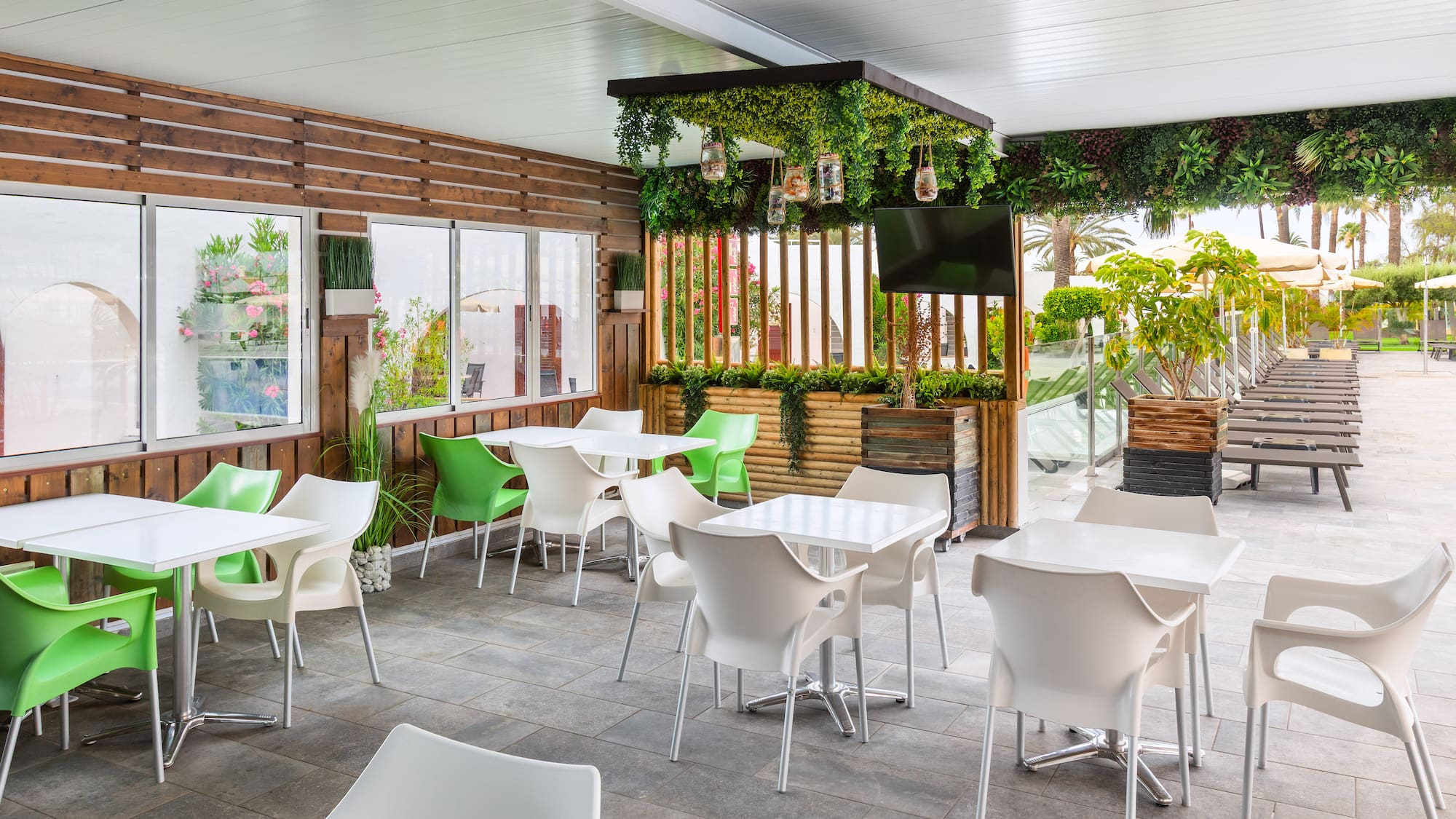 a patio with white tables and chairs