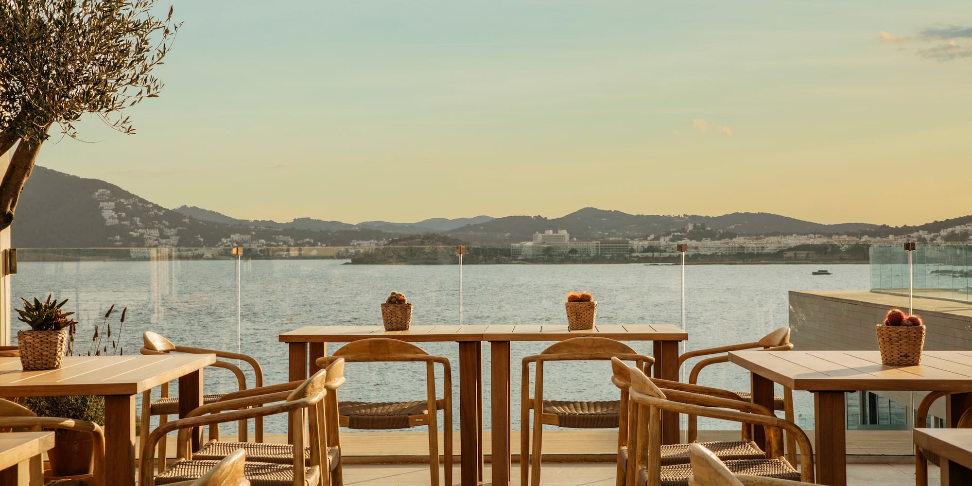 a table and chairs on a deck overlooking a body of water