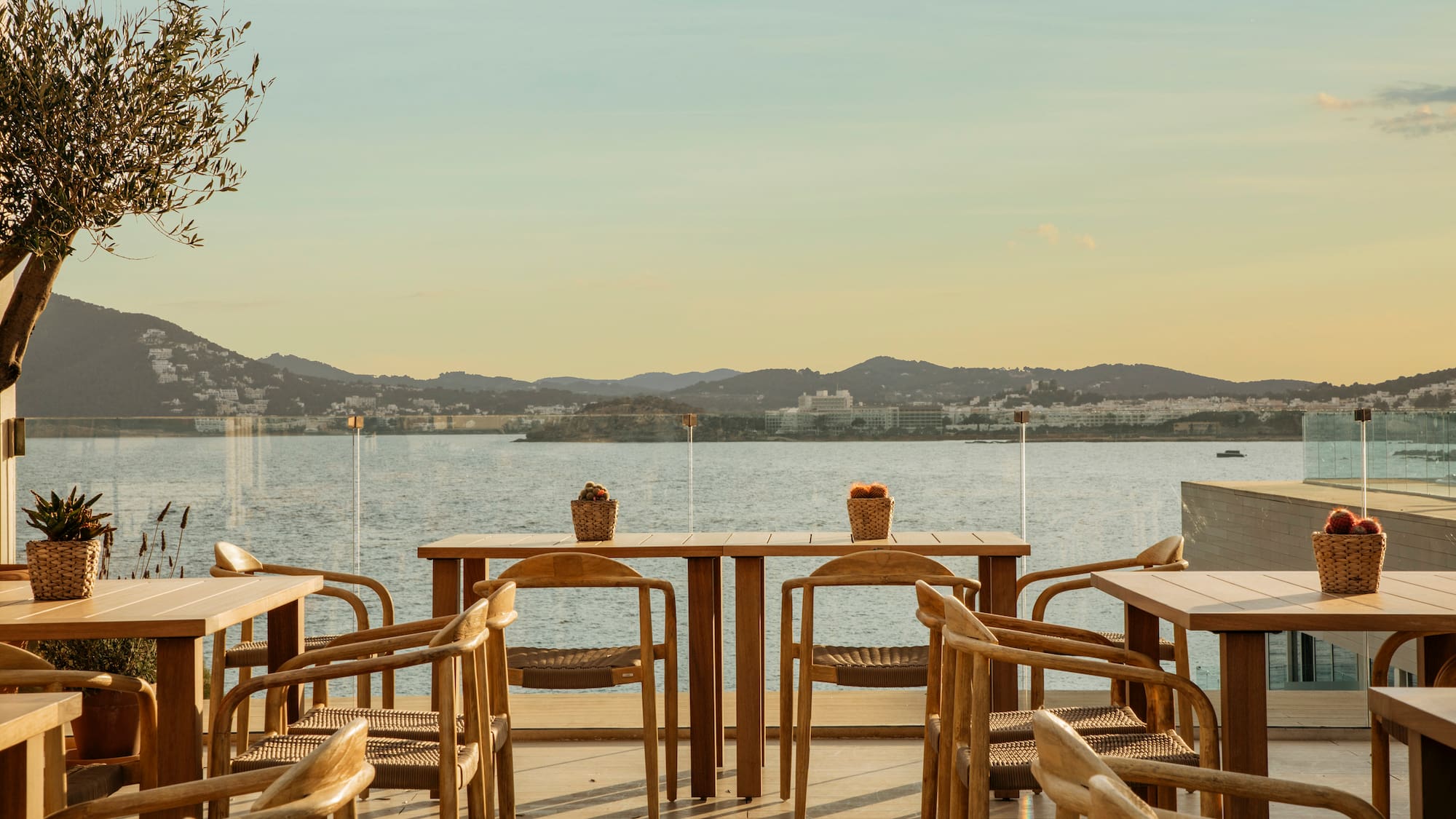 a table and chairs on a deck overlooking a body of water