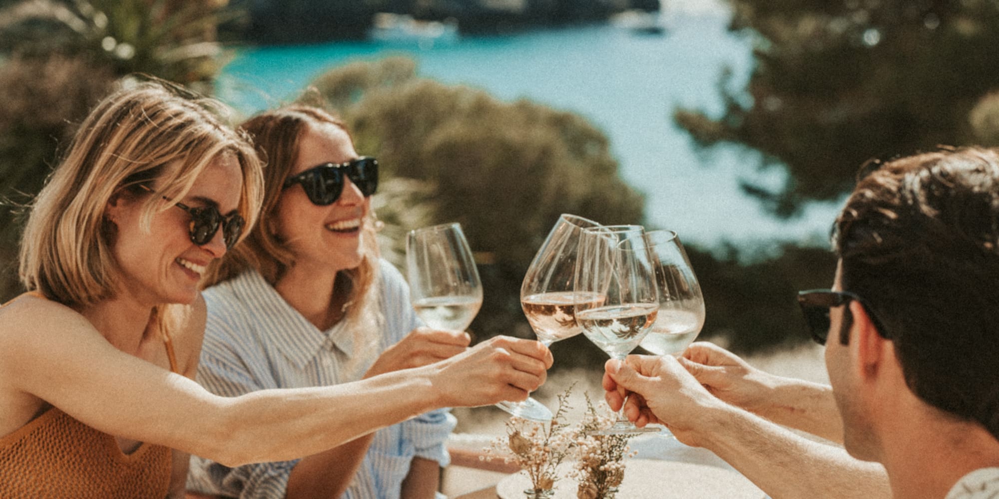a group of people clinking wine glasses at a table