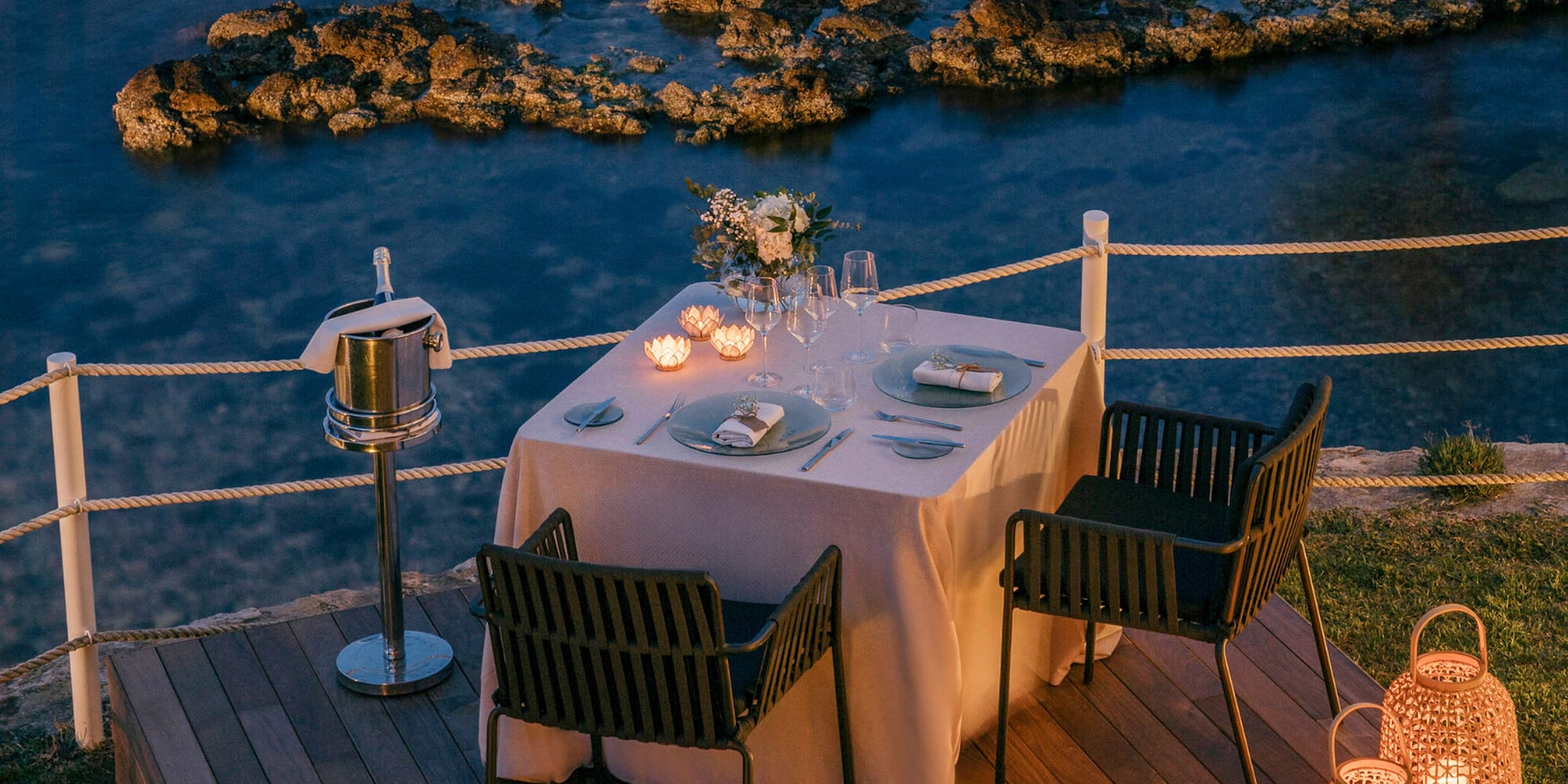 a table set up on a deck overlooking water