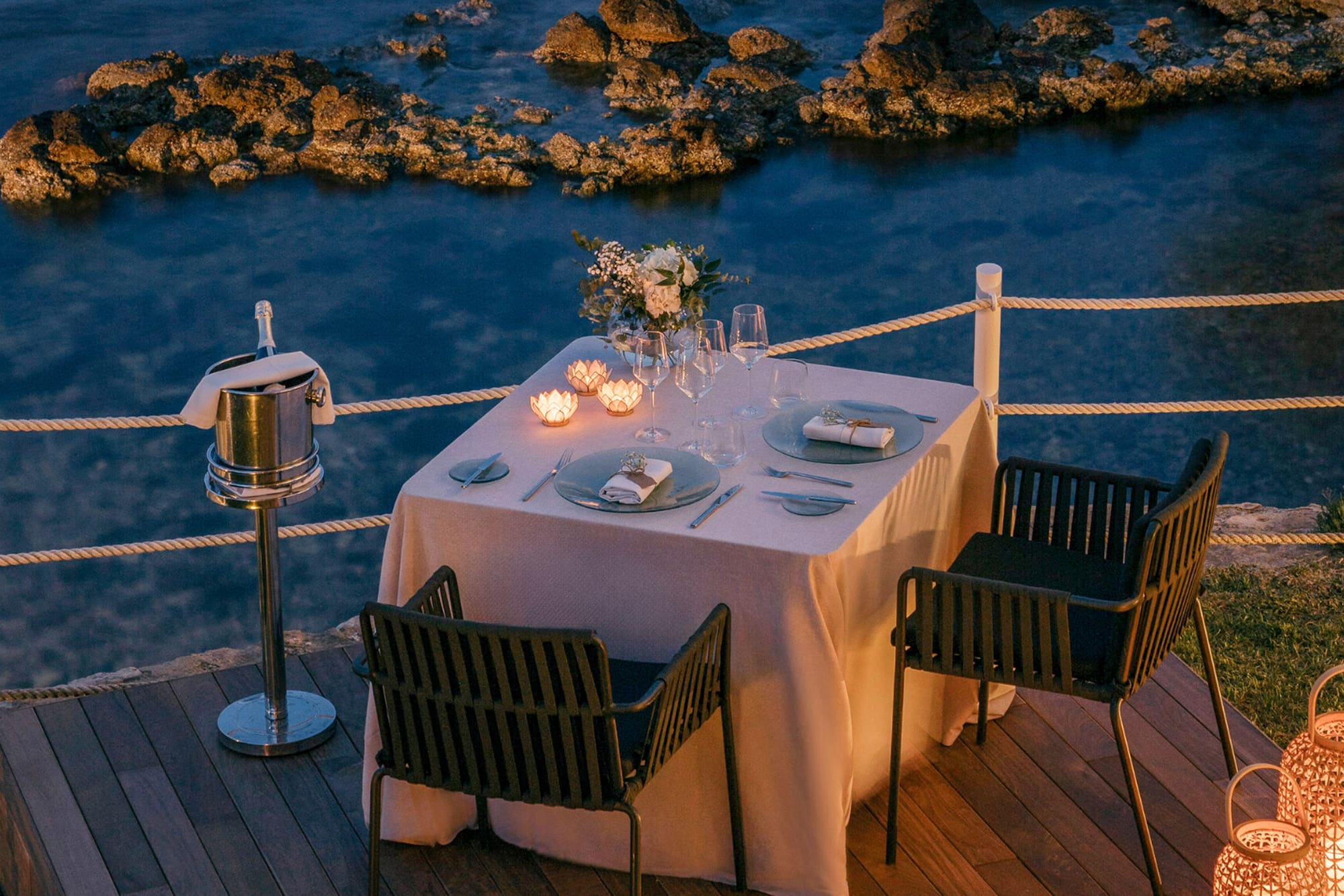 a table set up on a deck overlooking water