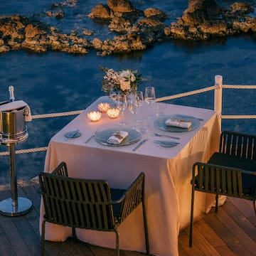a table set up on a deck overlooking water