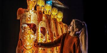 a girl touching a large display of human figures