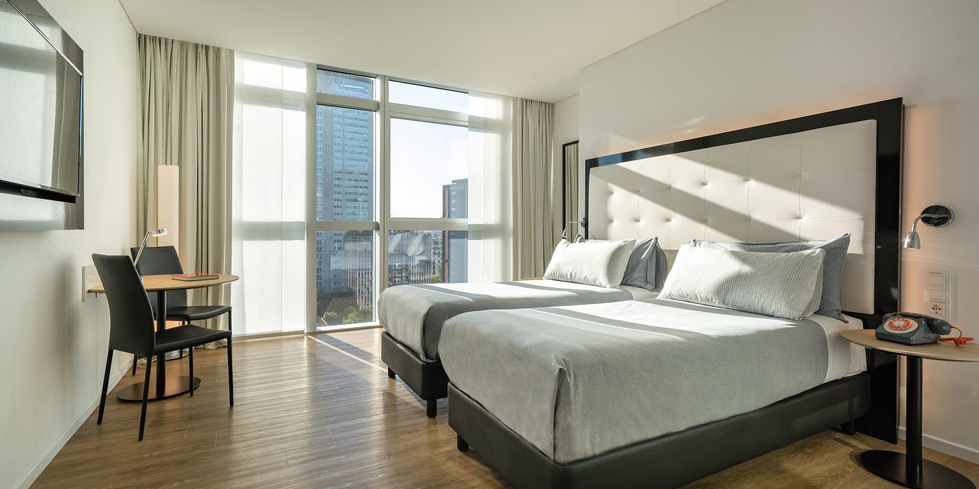 a room with two beds and a desk