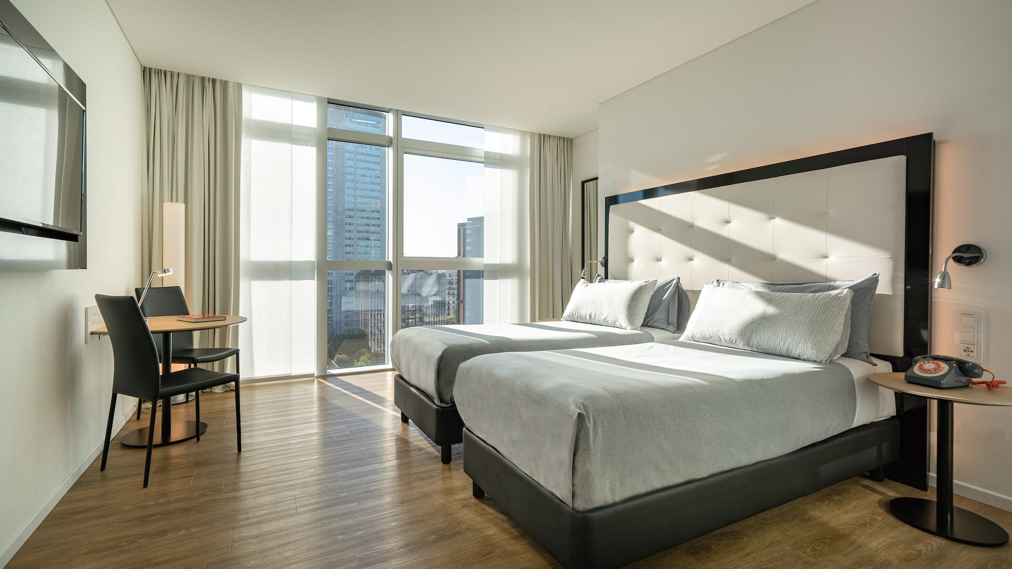 a room with two beds and a desk