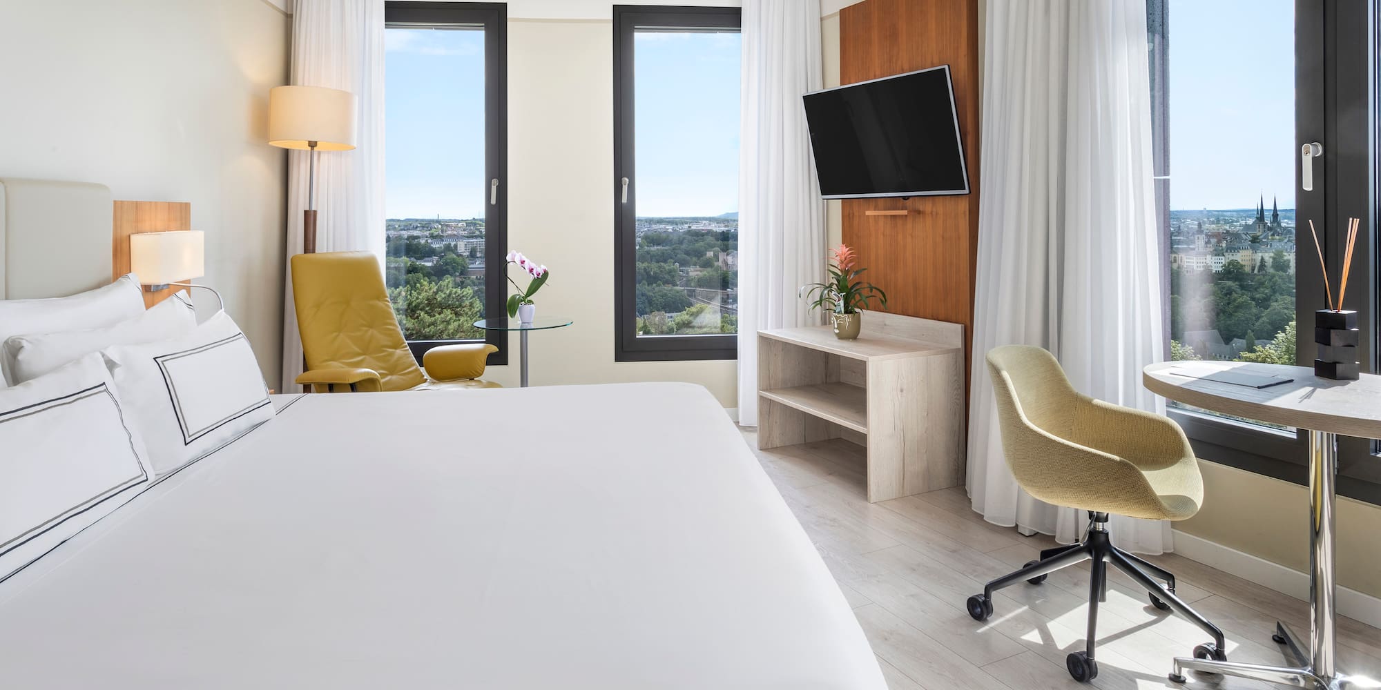 a room with a bed and a television