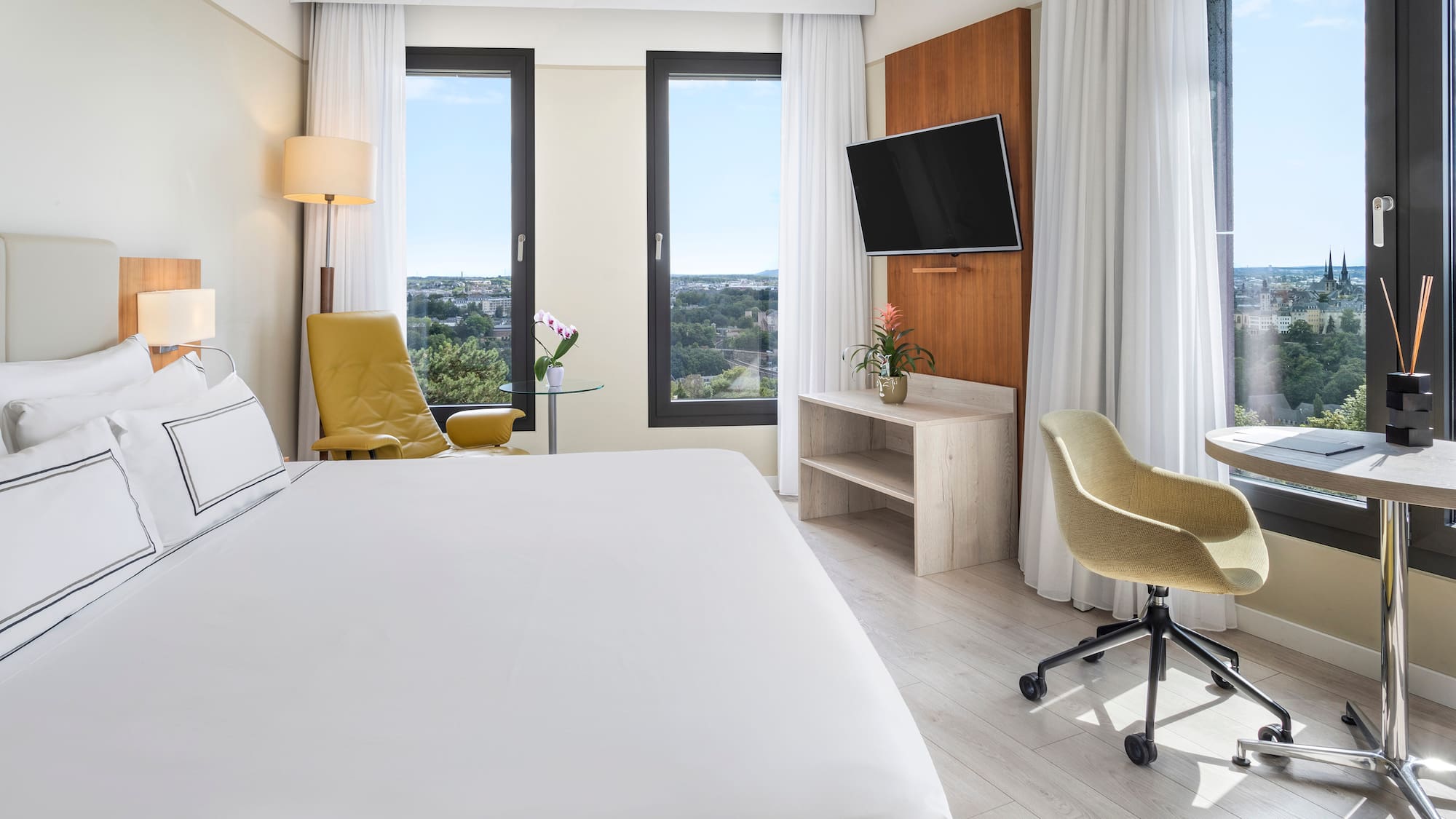 a room with a bed and a television