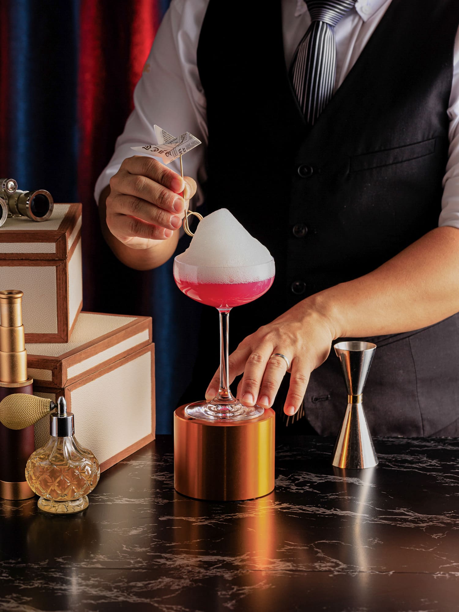 a person pouring a drink into a glass